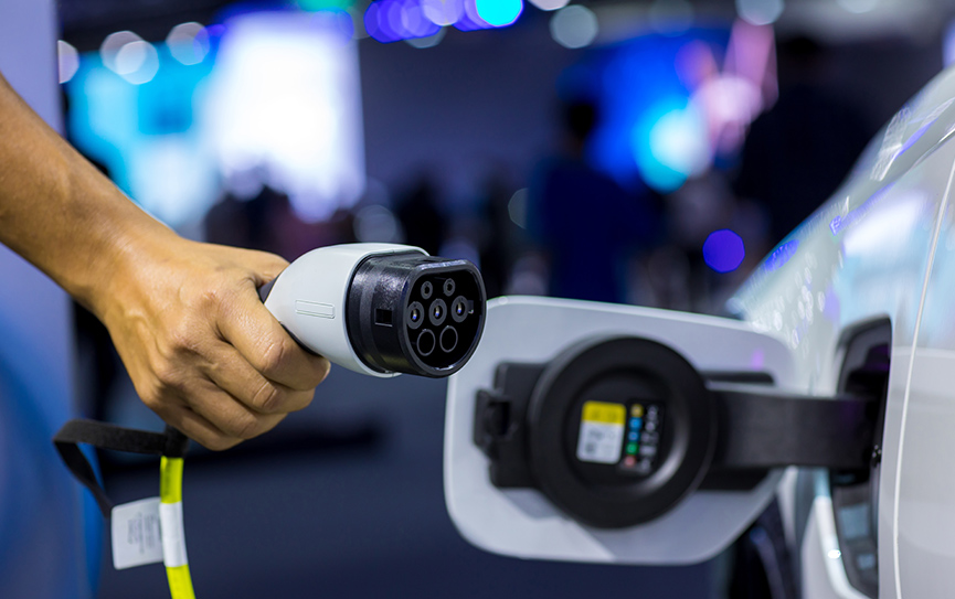 hand-holding-electric-car-charger-electric-vehicl-2022-11-16-14-02-45-utc.jpg